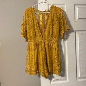 Mustard yellow romper with floral lace detail